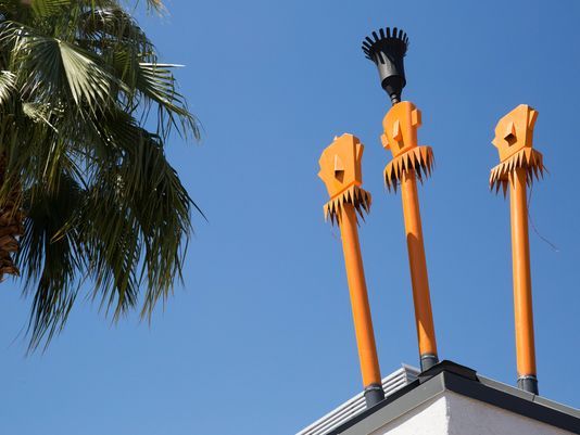 Tiki torch lighting set for Modernism Weekend